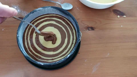 Zebra cake. Process of elaboration by pouring the mixture into the mold. Video stock 155993540