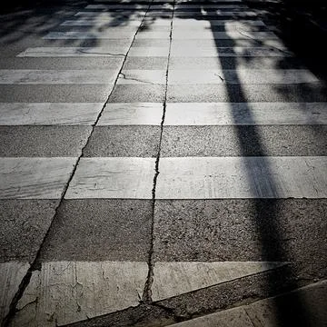 Zebra crossing with backlight in the old town of Porec in Croatia Stock Photos