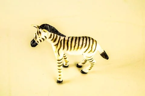 A zebra toy is sitting on a white surface Foto stock