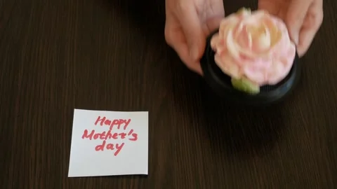 Zefir or marshmallows as pink rose and happy Mother's Day in hand, Gift box.. Stock Footage 332795388