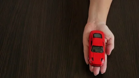 Zefir or marshmallows as pink rose and red car model in hand, Gift concept. Vídeo Stock 332795449