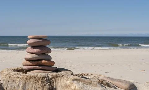 Zen concept. Sand and stack stones on dry log Stock Photos