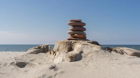 Zen concept. Sand and stack stones on dry log Stock Photos