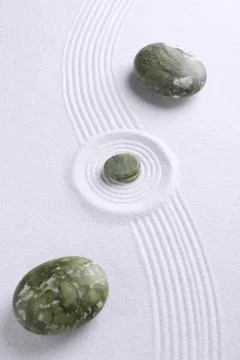 Zen concept. Stones and pattern on white sand Stock Photos