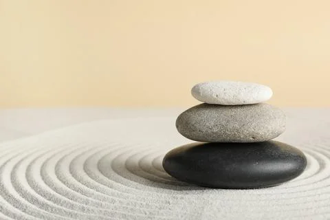 Zen garden stone stack with concentric sand circles, balance and harmony conc Stock Photos