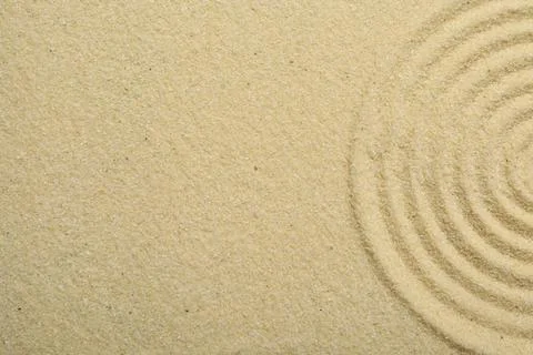 Zen rock garden. Circle pattern on beige sand, top view Stock Photos