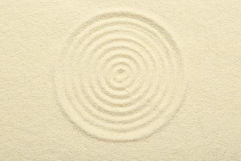 Zen rock garden. Circle pattern on beige sand, top view Stock Photos