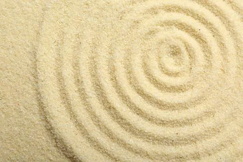 Zen rock garden. Circle pattern on beige sand, top view Stock Photos