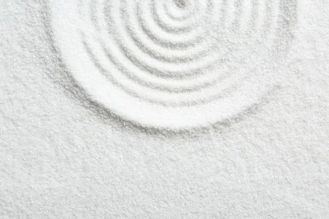 Zen rock garden. Circle pattern on white sand, top view. Space for text Stock Photos
