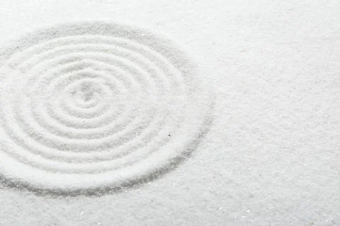 Zen rock garden. Circle pattern on white sand Stock Photos