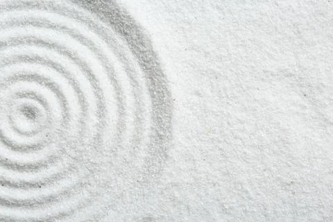 Zen rock garden. Circle pattern on white sand, top view. Space for text Stock Photos