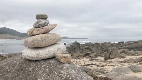 Zen rocks piled up in front of the sea Stock Footage 137906806
