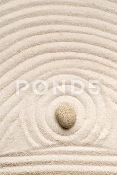 Zen sand and stone garden with raked lines, curves and circles. Simplicity, c Stock Photos
