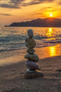 Zen stone tower on sunset background Foto stock