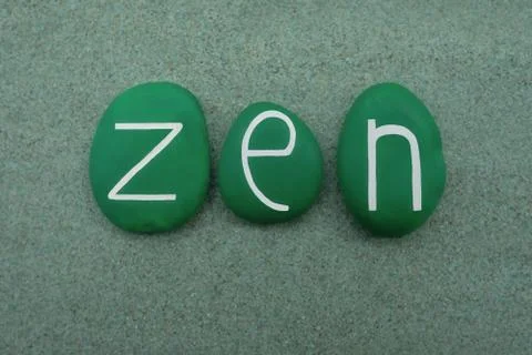Zen text composed with green colored stone letters over green sand Stock Photos