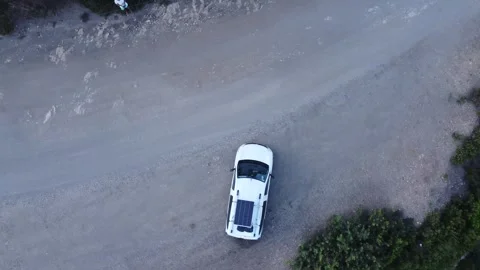 Zenith aerial shot of camper van with solar panel, Elba, Italy Видео 336332007