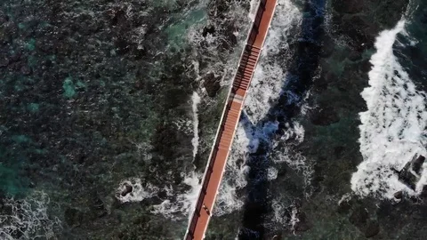 Zenith drone over bridge between land at coastline HD 5 Stock Footage 129256813