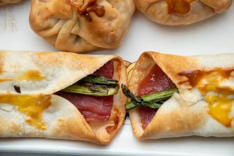 Zenithal macro view. Horizontal view of bags filled with cheese and tomato. S Stock Photos