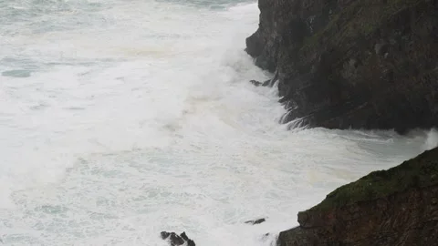 Zenithal view of a sea with large windstorm waves impacting against the cliff Stock Footage 254861269