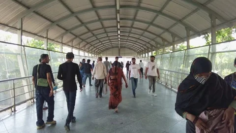 Зeople walk quickly along the overpass in Mumbai Stock Footage 313152420