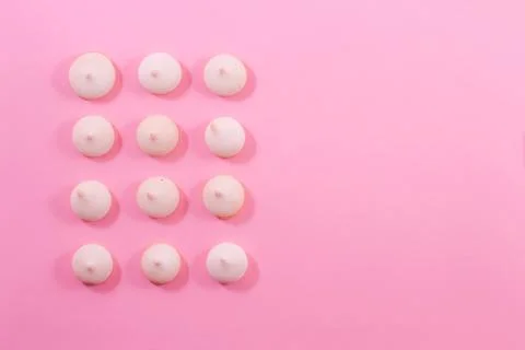 Zephyr biscuits on a light pink-red background. Stock Photos