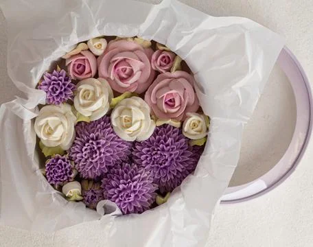 Zephyr bouquet of flowers in a gift box on a light background, holiday concep Stock Photos