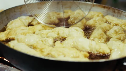Zeppole Cooking And Gaining The Gold Color Stock Footage 314864377