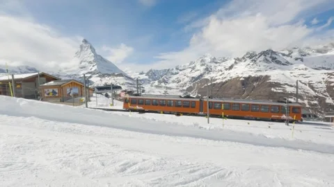 Zermatt ski resort train in winter near Matterhorn peak, Swiss Alps Stock Footage 304497136