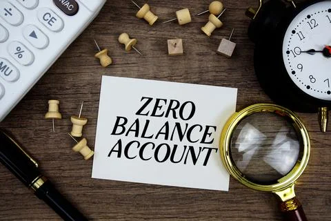 Zero Balance Account text written on notepad with pen, alarm clock, magnify.. Stock Photos