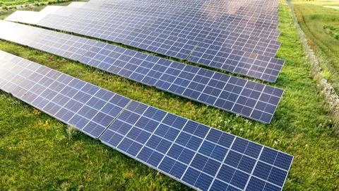 Zero-emission solar panels on a lush summer field, aerial perspective. Fotos Stock
