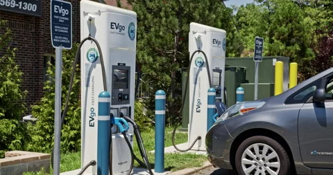 A zero emission vehicle gets a fast charge from the EVgo pump Stock Footage 137922095