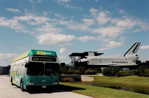 The Zero Emissions (ZE) transit bus passes a mock-up orbiter named Explore... Stock Photos