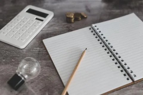 Zero fees message on lightbox surrounded by coins calculator Stock Photos