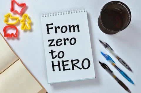 From zero to HERO text on notepad with office accessories. Business motivatio Stock Photos