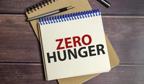 Zero hunger words on notepad and wooden background Stock Photos