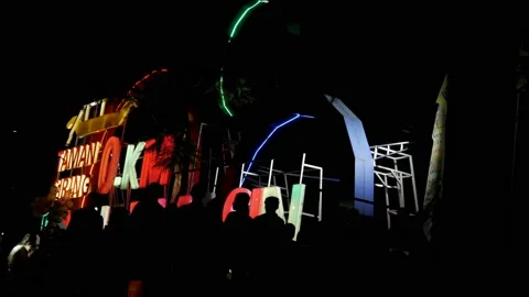 Zero Kilometer light sign, silhouette of people walking at night Stock Footage 141297096