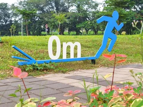 A zero point sign on a running track in a sports area Stock Photos