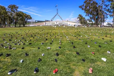 Zero Suicide Awareness Program display featuring boots laid out on the ground Stock Photos