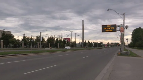 Zero tolerance distracted and texting driving police warning sign over highway Stock Footage
