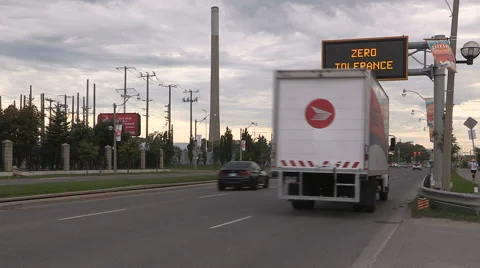 Zero tolerance distracted and texting driving police warning sign over highway Stock Footage