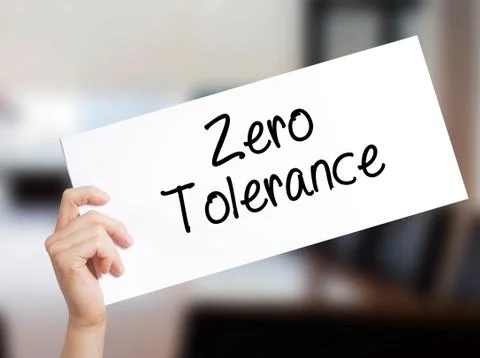 Zero Tolerance Sign on white paper. Man Hand Holding Paper with text. Isolate Foto stock