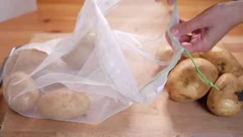 Zero vaste lifestyle concept Pull on potatoes of the reusable bag Stock Footage 107216446