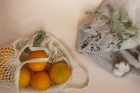 Zero waste and plastic-free lifestyle and shopping. Cotton mesh bag with fruits. Stock Photos
