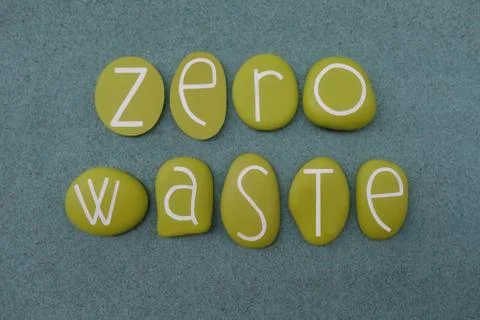 Zero Waste, composed with green colored stone letters over green sand Stock Photos