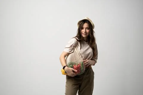Zero waste concept with copy space. Woman holding a reusable mesh shopping bag Stock Photos