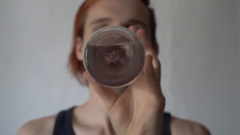 Zero waste concept. Man drinking water from a reusable glass bottle. 스톡 동영상 112861244