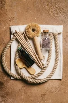 Zero waste concept. Set of brush for washing dishes, wooden spoon, glass bott Stock Photos