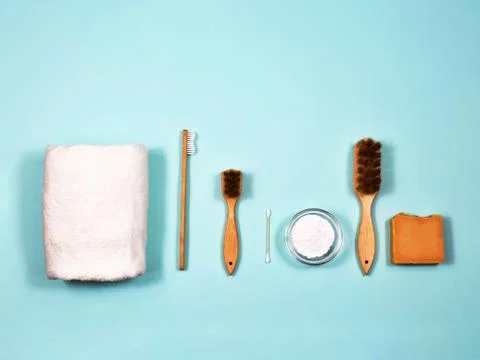 Zero waste concept. Toothbrush, tooth powder, towel, soap and brushes on a blue Stock Photos