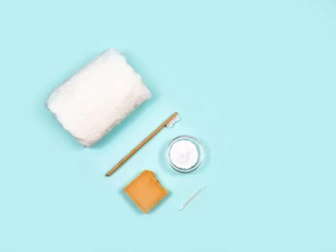Zero waste concept. Toothbrush, tooth powder, towel and soap on a blue Stock Photos