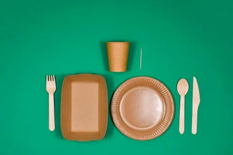Zero waste, eco-friendly, disposable, cardboard, paper utensils on a green ba Stock Photos